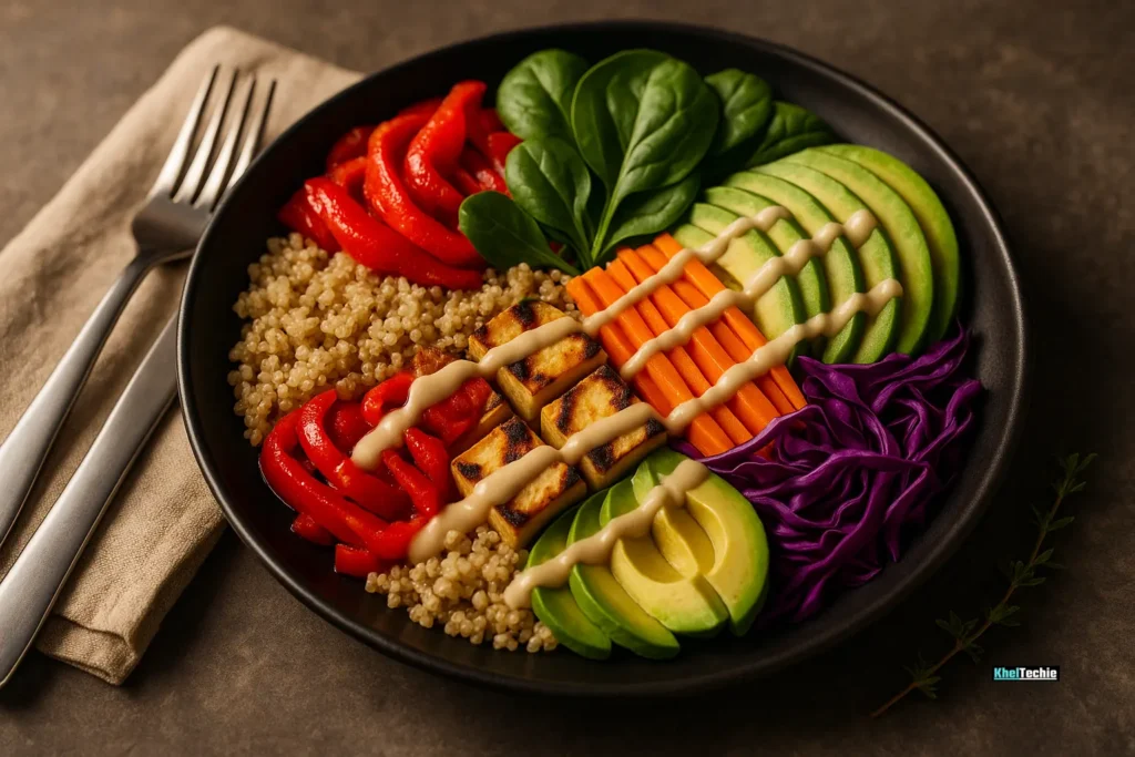 Colorful nutrient-rich rainbow bowl with veggies, tofu, and avocado on a black plate