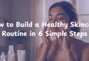 Woman following a morning skincare routine with clean products and natural lighting