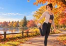 Person doing gentle stretching on a fall walking trail as part of a recovery routine.